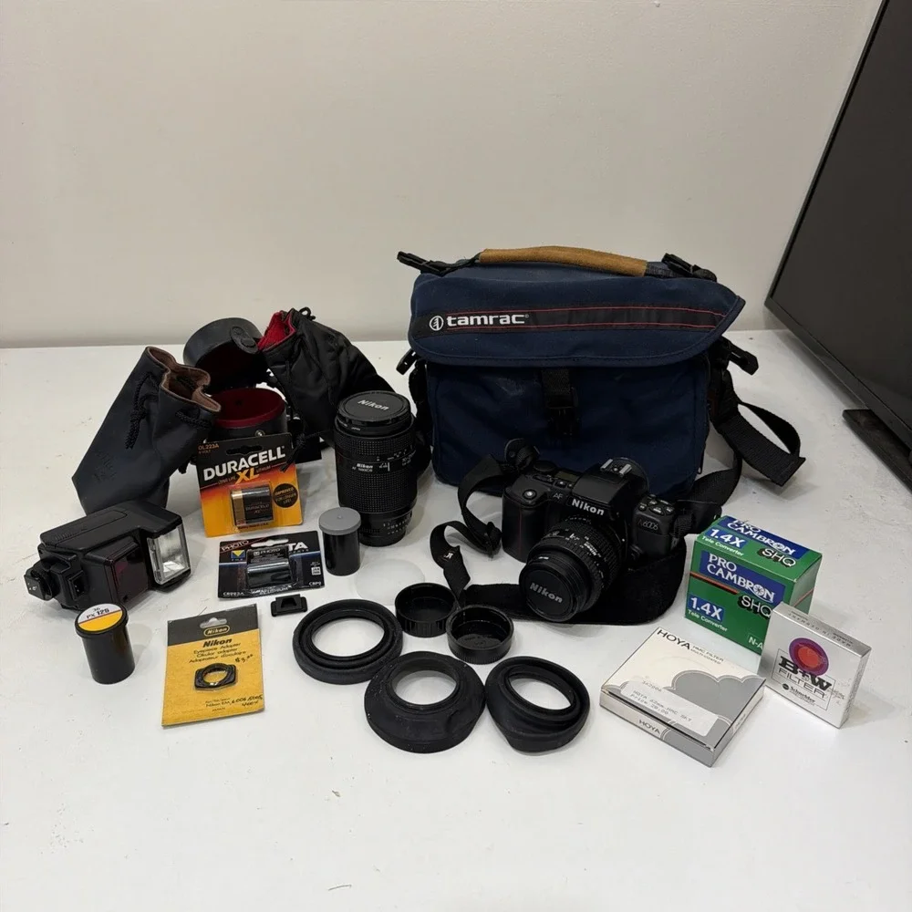 NIKON N6006 FILM SLR CAMERA. W/ ASSORTED LENSES AND ACCESSORIES. UNTESTED.